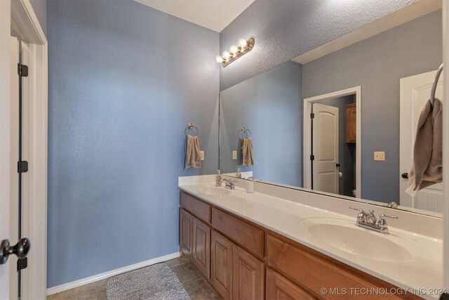 bathroom featuring tile patterned flooring and vanity