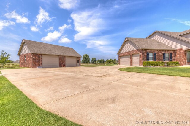 view of property exterior with a yard and a garage