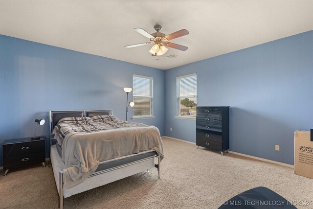 bedroom with ceiling fan and carpet