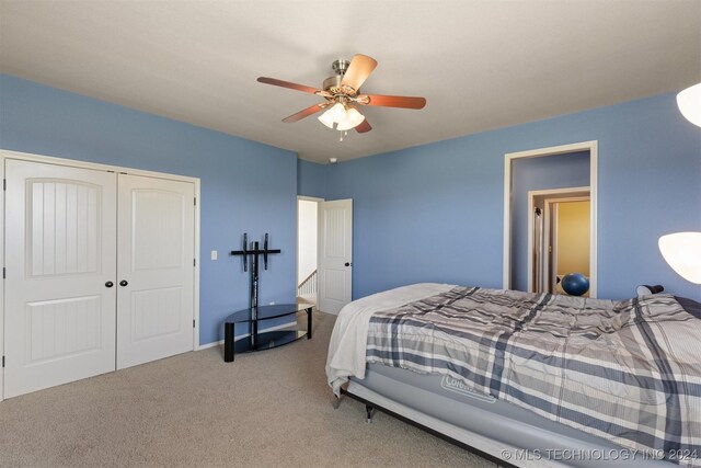 carpeted bedroom with a closet and ceiling fan