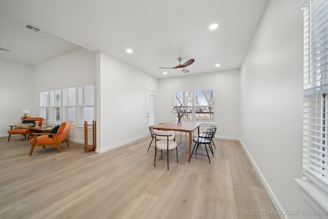 dining space with light hardwood / wood-style floors and ceiling fan