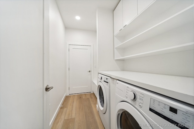 laundry room with separate washer and dryer and light wood-type flooring