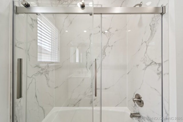 bathroom featuring bath / shower combo with glass door