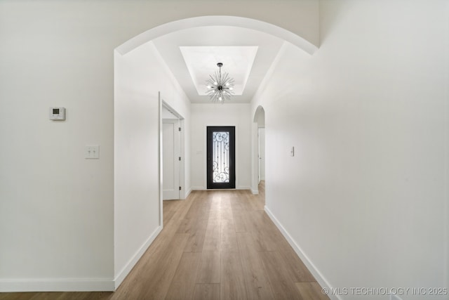 entryway with a notable chandelier and light wood-type flooring