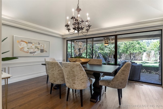 dining area featuring a notable chandelier, hardwood / wood-style floors, and ornamental molding