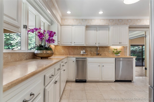 kitchen with sink, dishwasher, plenty of natural light, and backsplash