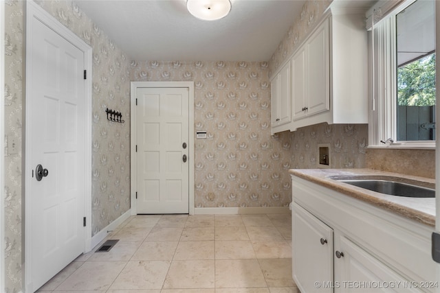 kitchen with light tile patterned floors and white cabinets