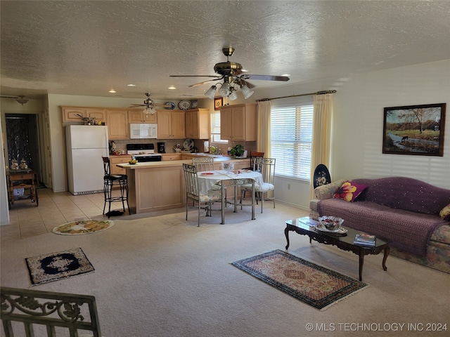 carpeted living room featuring a textured ceiling and ceiling fan