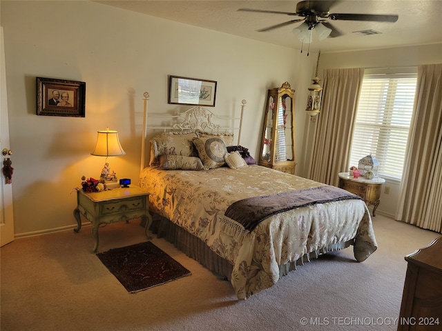 bedroom with ceiling fan and light carpet