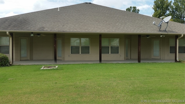 rear view of property with a patio area and a yard