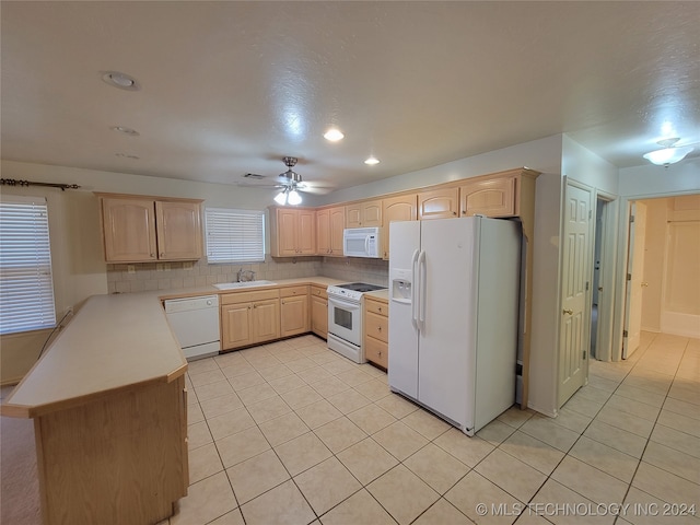 kitchen featuring backsplash, sink, white appliances, ceiling fan, and light brown cabinetry