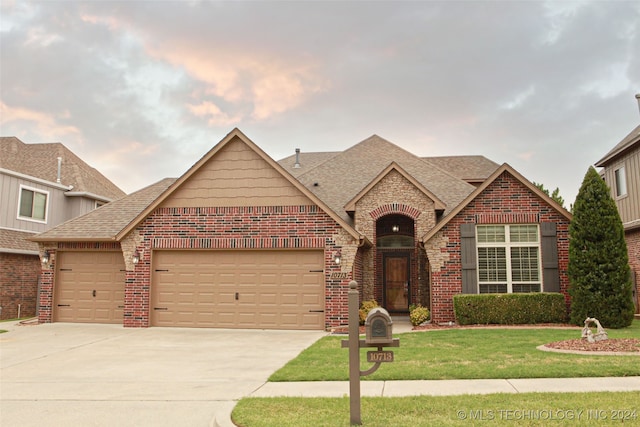 view of front of property with a garage and a front yard