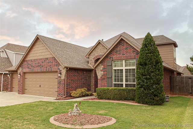 view of front of house with a garage and a front yard