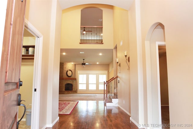 hall featuring hardwood / wood-style flooring and a high ceiling