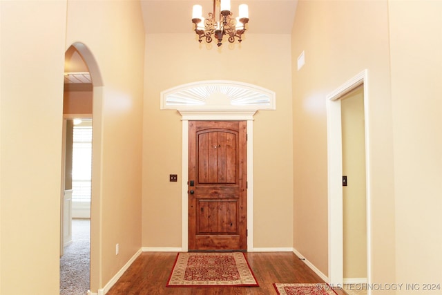 foyer entrance featuring carpet flooring and a notable chandelier