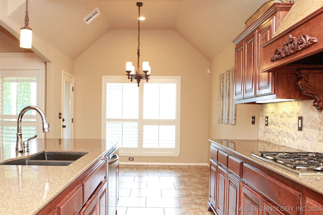 kitchen with light tile patterned flooring, sink, light stone countertops, tasteful backsplash, and stainless steel appliances