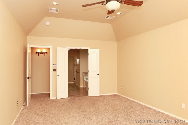 unfurnished bedroom with ceiling fan, carpet flooring, and lofted ceiling