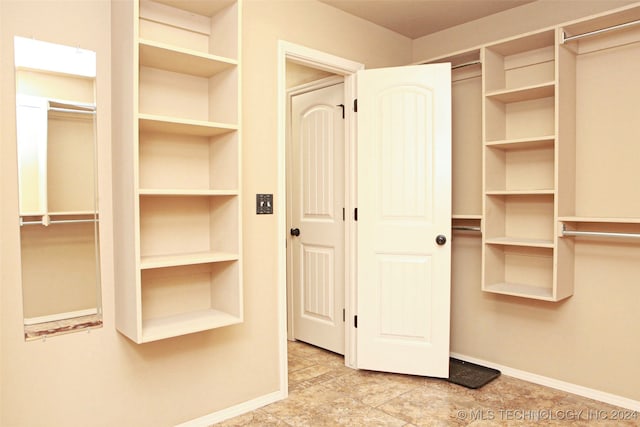 walk in closet featuring light tile patterned floors