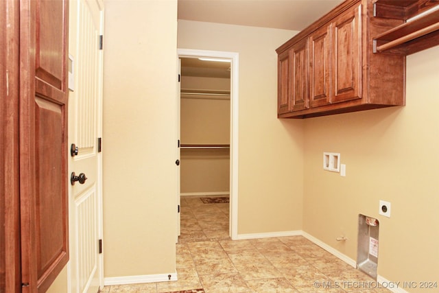 laundry room with gas dryer hookup, washer hookup, cabinets, electric dryer hookup, and light tile patterned flooring