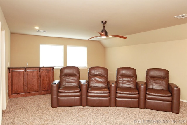 carpeted home theater room featuring ceiling fan and lofted ceiling