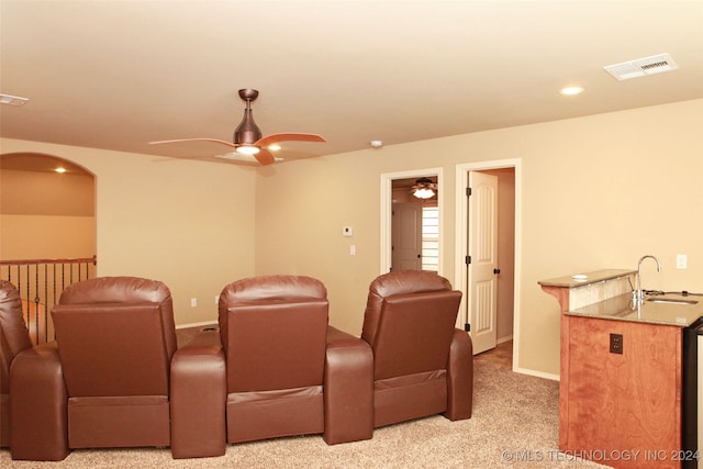 carpeted cinema featuring sink and ceiling fan