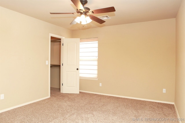 unfurnished room with ceiling fan and light colored carpet