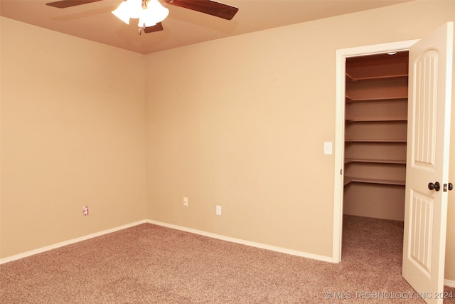 carpeted spare room with ceiling fan