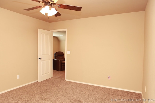 spare room featuring light colored carpet and ceiling fan