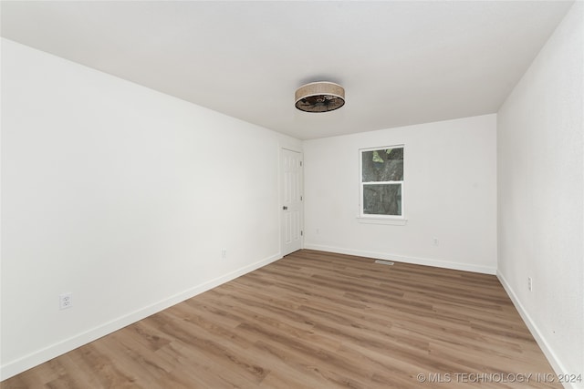 empty room with hardwood / wood-style flooring