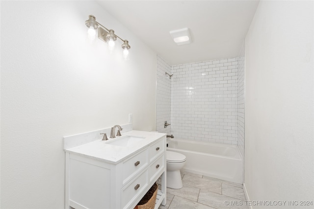 full bathroom featuring vanity, toilet, tiled shower / bath combo, and tile patterned floors