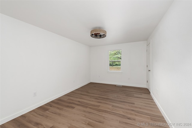 unfurnished room with hardwood / wood-style floors