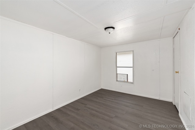 empty room featuring dark hardwood / wood-style flooring