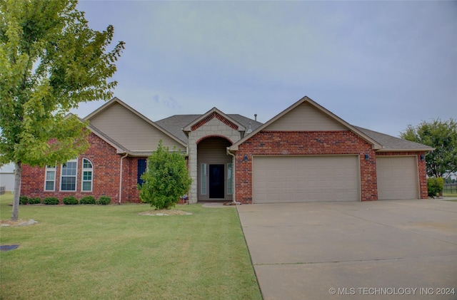 ranch-style home with a front yard, concrete driveway, brick siding, and an attached garage