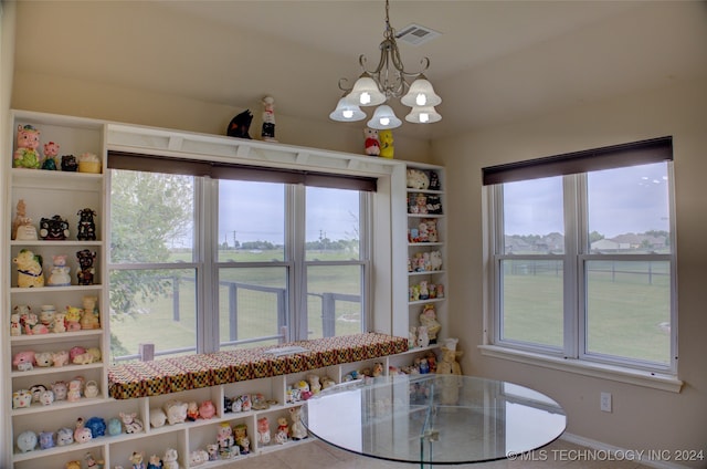 tiled dining space with an inviting chandelier