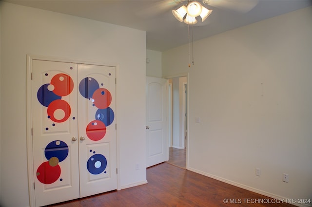 unfurnished bedroom featuring ceiling fan and dark hardwood / wood-style flooring