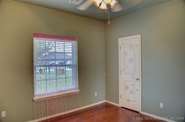 spare room with ceiling fan and dark hardwood / wood-style floors