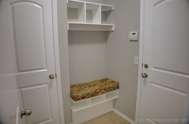 mudroom featuring light tile patterned floors and baseboards