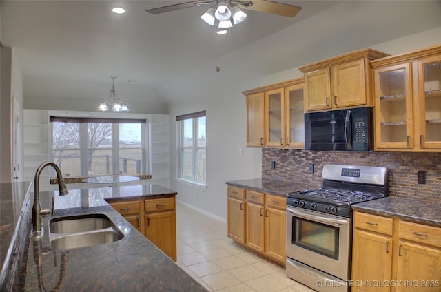 kitchen featuring black microwave, light tile patterned floors, a sink, tasteful backsplash, and gas stove