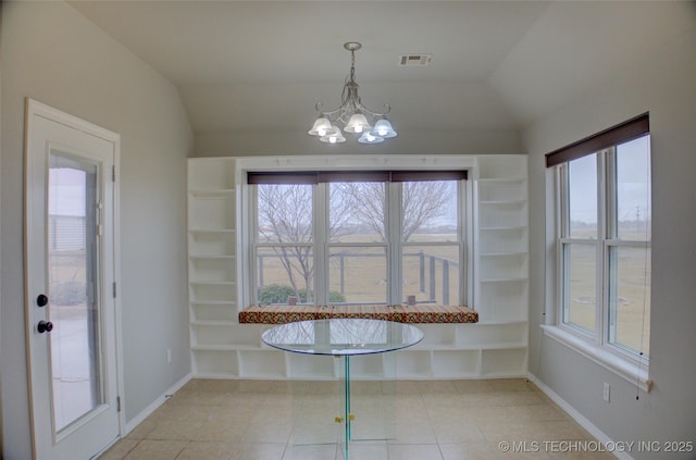 unfurnished dining area featuring vaulted ceiling, a healthy amount of sunlight, and a notable chandelier