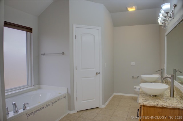 bathroom with a bath, double vanity, a sink, and tile patterned floors