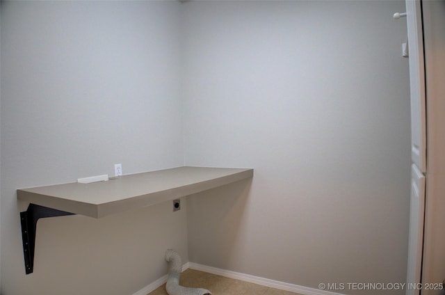 laundry room featuring baseboards, laundry area, light tile patterned floors, and hookup for an electric dryer