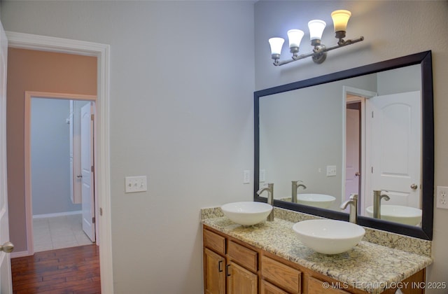 bathroom featuring a sink and double vanity