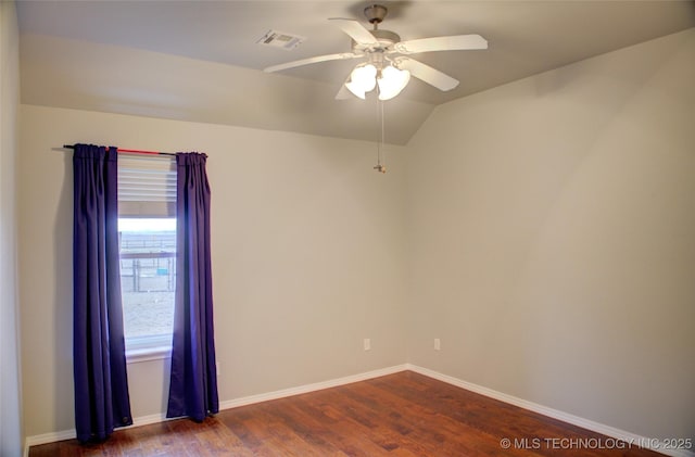 empty room with a ceiling fan, dark wood finished floors, visible vents, and baseboards