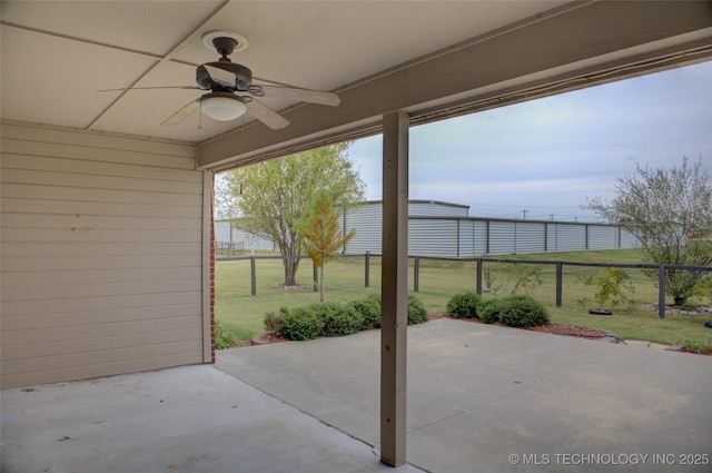 view of patio / terrace featuring ceiling fan and fence