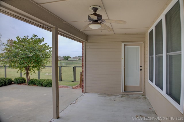 view of patio / terrace with a ceiling fan and fence