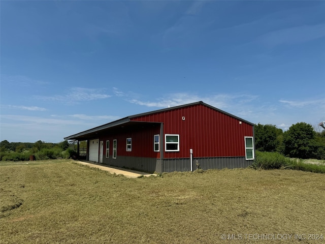 view of outbuilding featuring a lawn