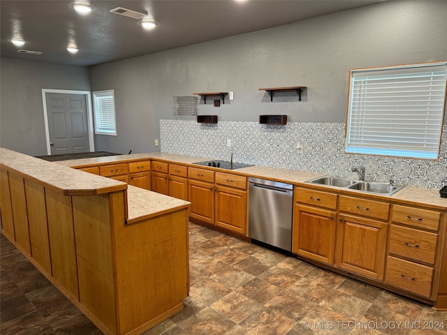 kitchen featuring backsplash, sink, dark tile patterned floors, and dishwasher