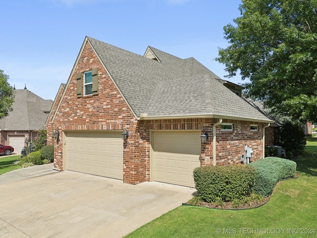 view of front of property with a garage and a front lawn