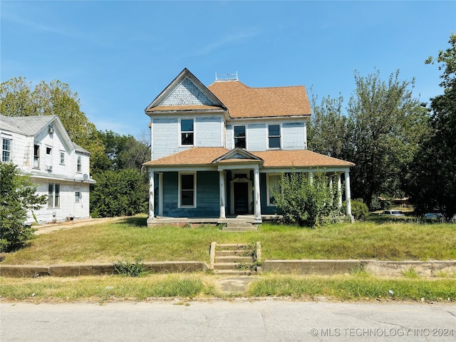 victorian-style house featuring a porch