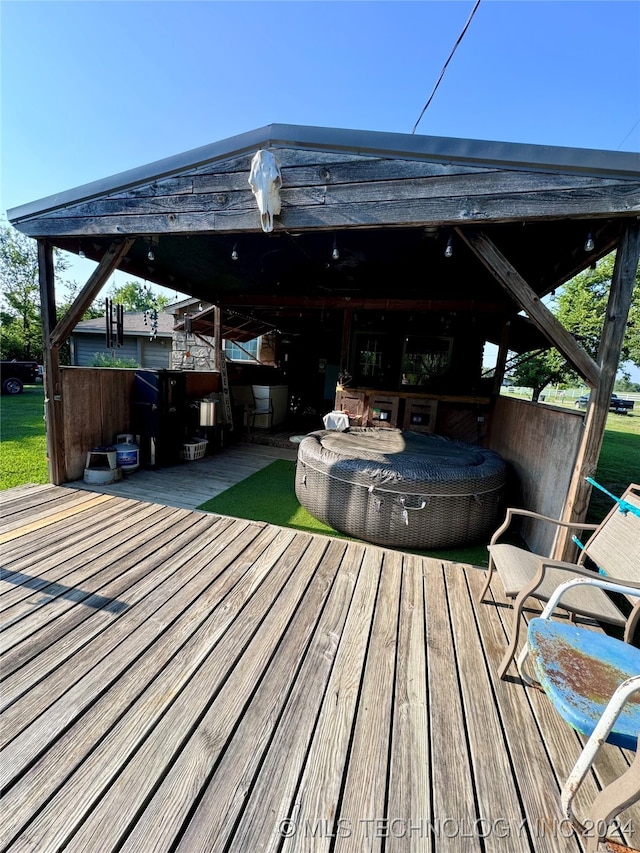 wooden terrace featuring a covered hot tub